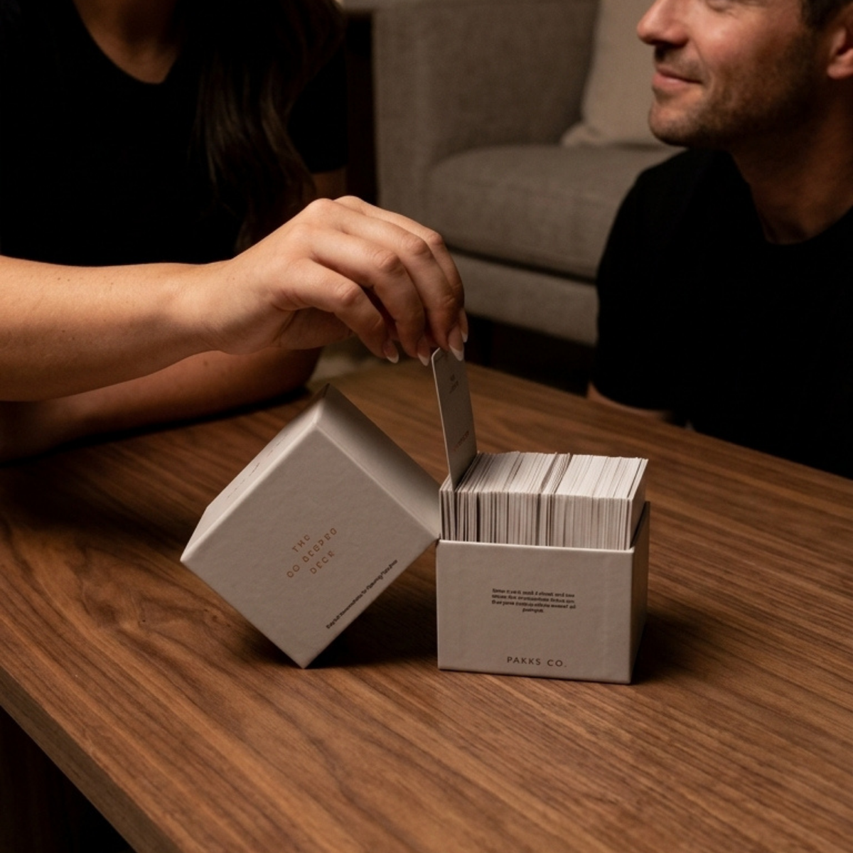 A hand choosing a card from the Go Deeper Deck.