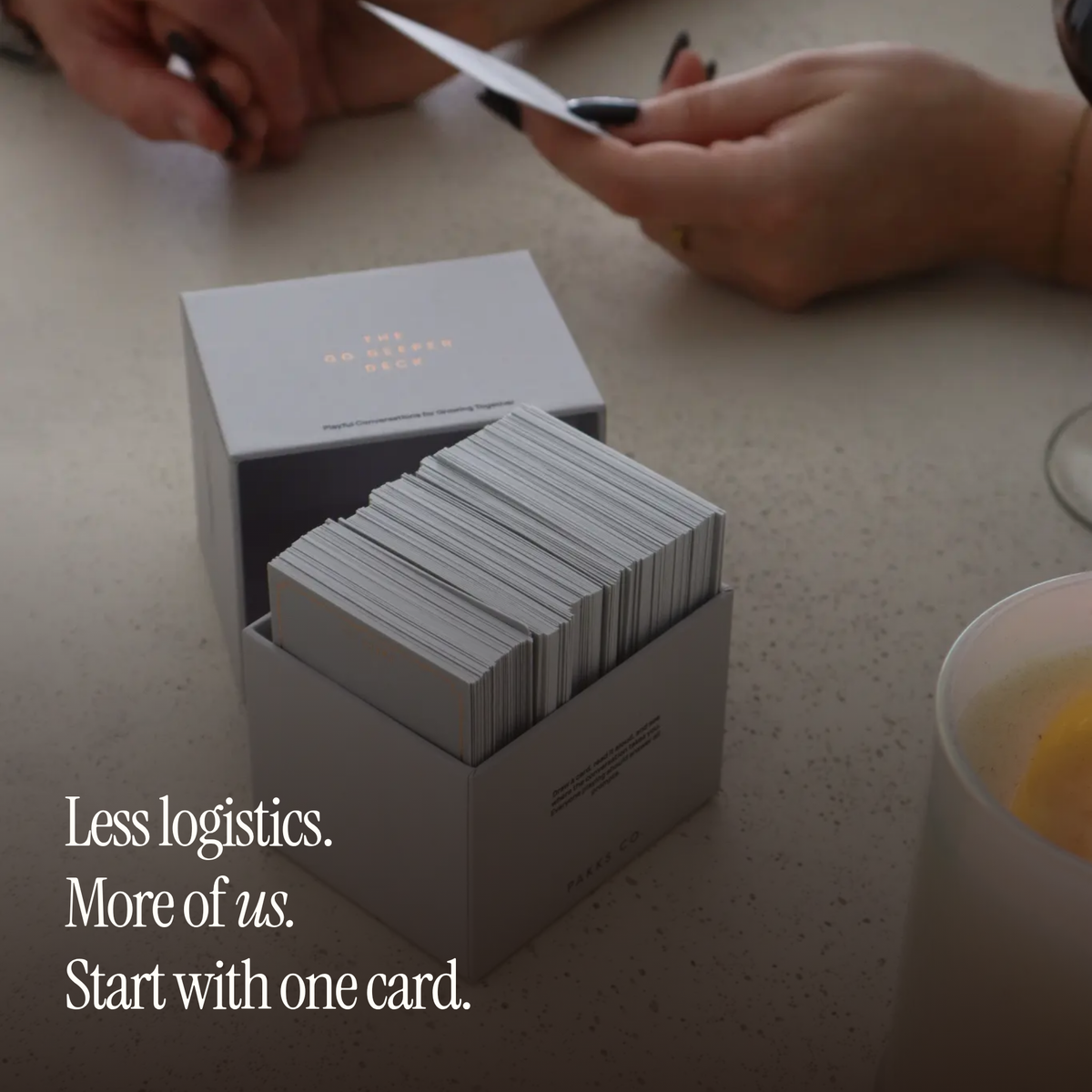 Hands drawing a card from the open Go Deeper box, with the words "Less logistics. More of us. Start with one card."