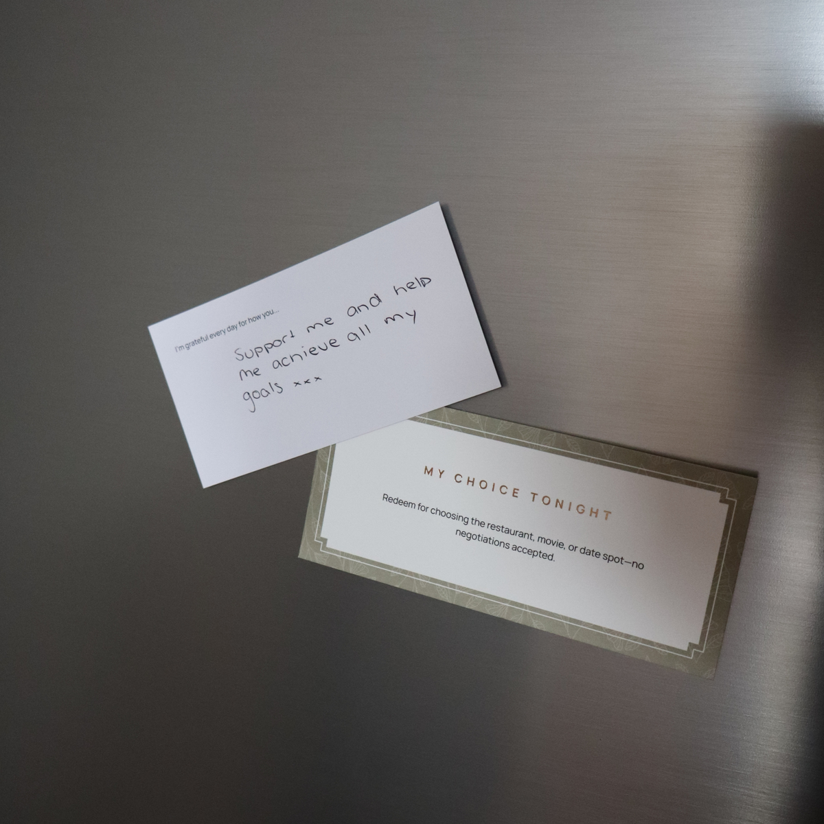 A handwritten Appreciation Note and a "My Choice Tonight" coupon stuck to a stainless steel fridge